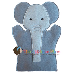 May include: A gray and light gray felt elephant hand puppet with black eyes and a white stitched outline. The puppet has large ears and a long trunk. The text "The Applique Place" is printed at the bottom.