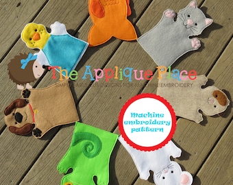 May include: A set of 7 felt finger puppets, including a fish, cat, chick, dog, chameleon, mouse, and a bear. The puppets are designed for machine embroidery and are arranged in a circle on a wooden surface. The text "The Applique Place" and "Machine Embroidery Pattern" are visible in the image.