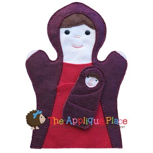 May include: A felt puppet of Mary holding a felt baby Jesus puppet. Mary is wearing a red dress and a purple robe. The baby Jesus is wrapped in a purple blanket. The puppets are made by The Applique Place.