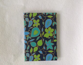 Codex bound handmade journal.  Lime green, aqua, and sky blue floral on navy blue background.