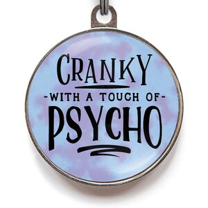 Funny dog tag - Cranky with a touch of psycho. Shown in cloudy blue