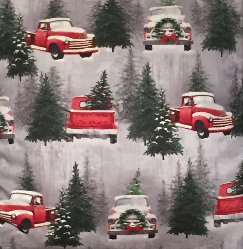 May include: A seamless pattern featuring red vintage pickup trucks carrying Christmas trees against a gray and white snowy background. The trucks are decorated with wreaths and bows.