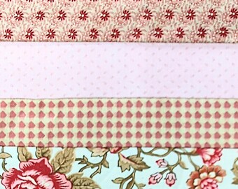 May include: A close-up of a fabric scrap quilt with five horizontal strips of fabric. The top strip is a solid pink, the second strip is a light pink with a small red floral pattern, the third strip is a light green with a pink and white checkered pattern, the fourth strip is a light blue with a pink floral pattern, and the bottom strip is a peach color.