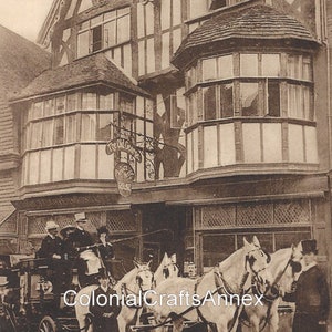 May include: A black and white photo of a historic building with a sign that reads "The Old George Hotel, Salisbury. An early 19th Century Inn."