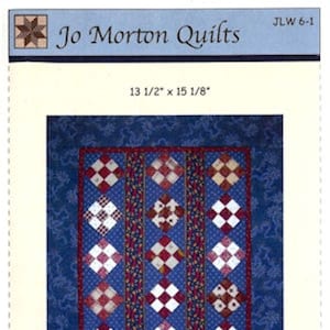May include: A quilting pattern titled "Mini Nine Patch Strippy" by Jo Morton Quilts. The pattern features a quilt design with red, white, and blue squares on a blue background. The finished quilt measures 13 1/2 inches by 15 1/8 inches.