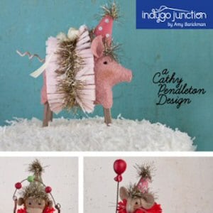 May include: A set of three felt circus animal ornaments: a pig wearing a pink tutu and party hat, a monkey juggling red balls, and a mouse holding a red balloon and wearing a pink tutu and party hat. The ornaments are part of the "Welcome to the Show" Circus Collection I by Cathy Pendleton Design.