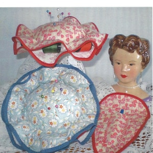 May include: A redwork embroidery pattern for a pin cushion that holds 8 spools of thread. The pattern includes a pin cushion, a seam ripper holder, and a scissor holder. The pattern is titled "Pin Cushion Treats" and says "This Project Recycles!!!".
