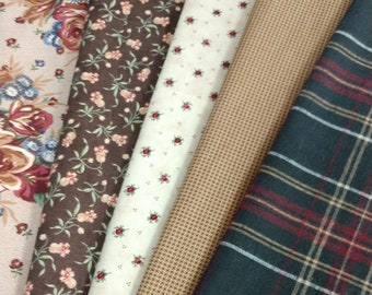 May include: Five different fabric swatches, including a floral print, a brown floral print, a white print with red dots, a brown and white houndstooth print, and a black and red plaid print.