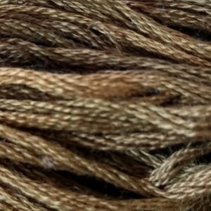 May include: Close-up of a skein of brown embroidery floss. The floss has a variegated color pattern, with shades of light and dark brown. The strands are tightly wound together, creating a textured appearance. Ideal for embroidery and other crafts.
