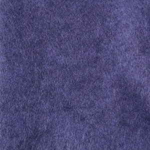 May include: A close-up of a textured, purple fabric. The fabric has a soft, fuzzy appearance.