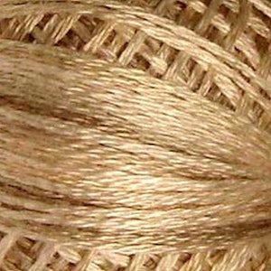 May include: A spool of beige embroidery floss.