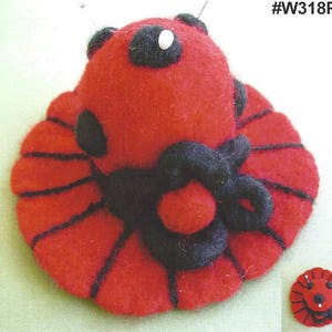 May include: Red felt pincushion shaped like a ladybug with black accents and a white spot. #W318P