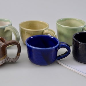 Assorted mugs, hand thrown porcelain and stoneware, assorted colors and sizes 7 - 10 oz