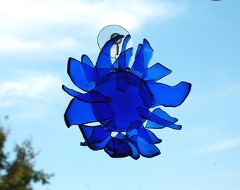 Upcycled glass flower sun catcher made from blue recycled bottles