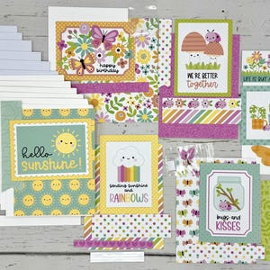 May include: A set of 10 blank greeting cards with colorful envelopes, featuring a variety of designs with a whimsical, nature-inspired theme. The designs include butterflies, flowers, rainbows, and bugs. The cards are perfect for sending a special message to someone you care about.