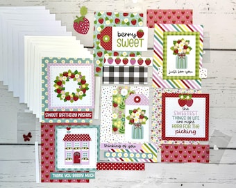 May include: A collection of handmade greeting cards with strawberry and floral designs. The cards feature phrases like "Sweet Birthday Wishes," "Thank You Berry Much," and "The Sweetest Things in Life." Includes envelopes and decorative elements.