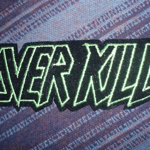 May include: Black and green embroidered patch with the word "NERML" in a stylized font.