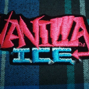 May include: An embroidered patch featuring the text "Vanita Ice" in a stylised font, with pink and blue lettering.