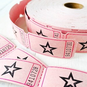 May include: Pink roll of tickets with a star design and the numbers 9410731, 9410728, 9410725, and 9410727 printed on them.