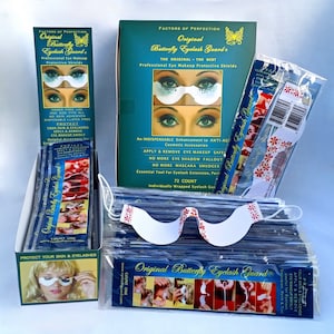 May include: A box of 72 individually wrapped Original Butterfly Eyelash Guards, a professional eye makeup protective shield. The box is blue and white with a butterfly design. The guards are white with a blue and red butterfly design. The text on the box reads "Original Butterfly Eyelash Guard - The Original - The Best".