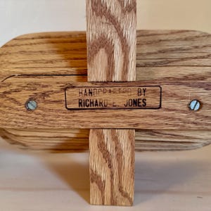 May include: A wooden bowl with a hand-crafted label that reads "HANDCRAFTED BY RICHARD E. JONES".