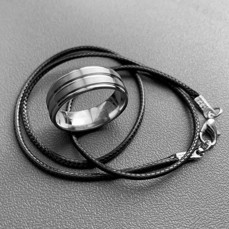 Dean Winchester wedding ring with a black cord necklace