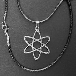 May include: A silver necklace with a black cord and a pendant shaped like an atom. The pendant is detailed with a circle in the center and four arms extending out.