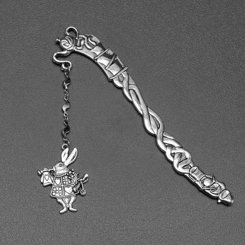 Alice in Wonderland tea party themed metal bookmark with a white rabbit charm.