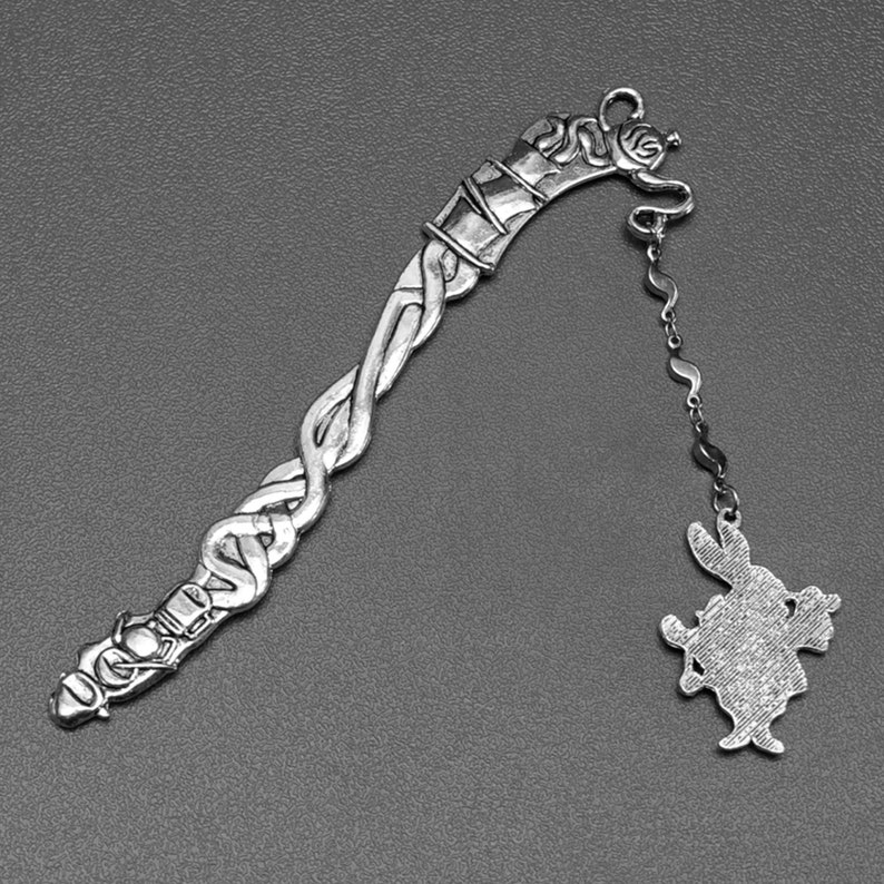 Alice in Wonderland tea party themed metal bookmark with a white rabbit charm reverse side