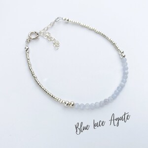 May include: A delicate bracelet made with silver beads and blue lace agate stones. The bracelet has a silver clasp and is perfect for everyday wear.