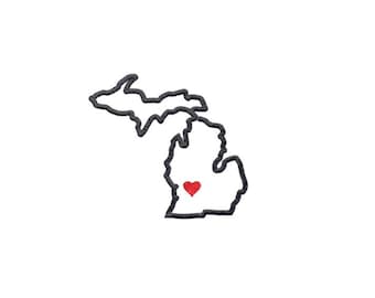 May include: A black outline of the state of Michigan with a red heart in the centre.