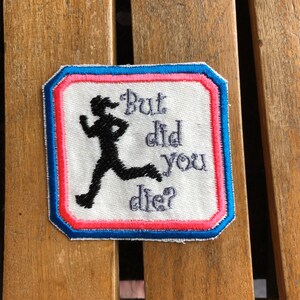 May include: A white patch with blue, pink, and red borders. The patch features a black silhouette of a running person and the text "But did you die?"