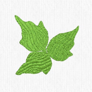 May include: A green embroidered butterfly design. The butterfly has three visible wings with a textured, wood-grain appearance. The embroidery is on a white, textured background.