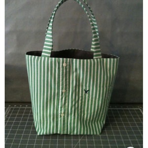 Small tote bag made from a men's button-down shirt. Bag depicted is from a green and white striped shirt