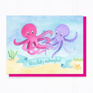 May include: A watercolor illustration of two octopuses, one pink and one purple, with their tentacles intertwined. The octopuses are swimming in a blue ocean with a sandy bottom. A banner with the text "blissfully entangled" is below the octopuses.