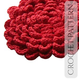 May include: Close-up of a vibrant red crocheted item with a textured, layered design. The item's surface is made up of repeating, rounded shapes. The text "CROCHET PATTERN" is visible on the right side of the image.