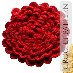 May include: A vibrant red crocheted flower with a layered petal design. The handmade craft features a circular shape and a textured surface. The image includes the text "CROCHET PATTERN" in a vertical white bar.