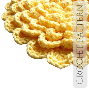 May include: Close-up of a yellow crochet pattern. The handmade item features a textured, floral design with a repeating pattern. The image includes the text "CROCHET PATTERN" in a vertical orientation.