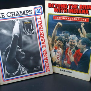 May include: Two vintage books about Indiana basketball. The book on the left is titled "The Champs '81" with a black and white image of a basketball player. The book on the right is titled "Beyond the Brink with Indiana" with a color image of a team celebrating.