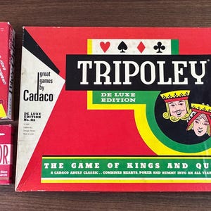 May include: A Tripoley De Luxe Edition board game box by Cadaco, featuring red, green, and yellow graphics with a king and queen illustration. Beside it are a red box of Aviator poker playing cards and a vertical box of colorful plastic poker chips.