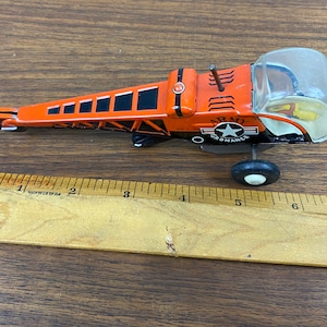 Vintage 1950&#39;s Tin Friction Orange Arm Ordinance Helicopter Toy 6 1/2&quot; - Made in Japan