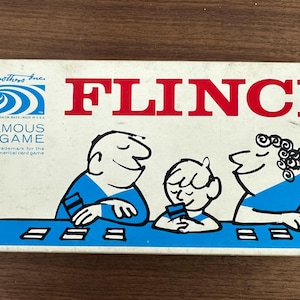 May include: Vintage Flinch card game box. The box features the word "FLINCH" in red block letters. The box art depicts three cartoon figures playing cards. The game is from Parker Brothers.