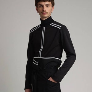 May include: A black long-sleeved shirt with white stripes and a matching black and white striped pants.