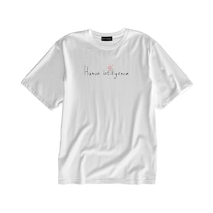 May include: White t-shirt with the text "Human intelligence" written in black cursive.