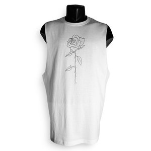 May include: White sleeveless shirt with a black line drawing of a rose on the front.