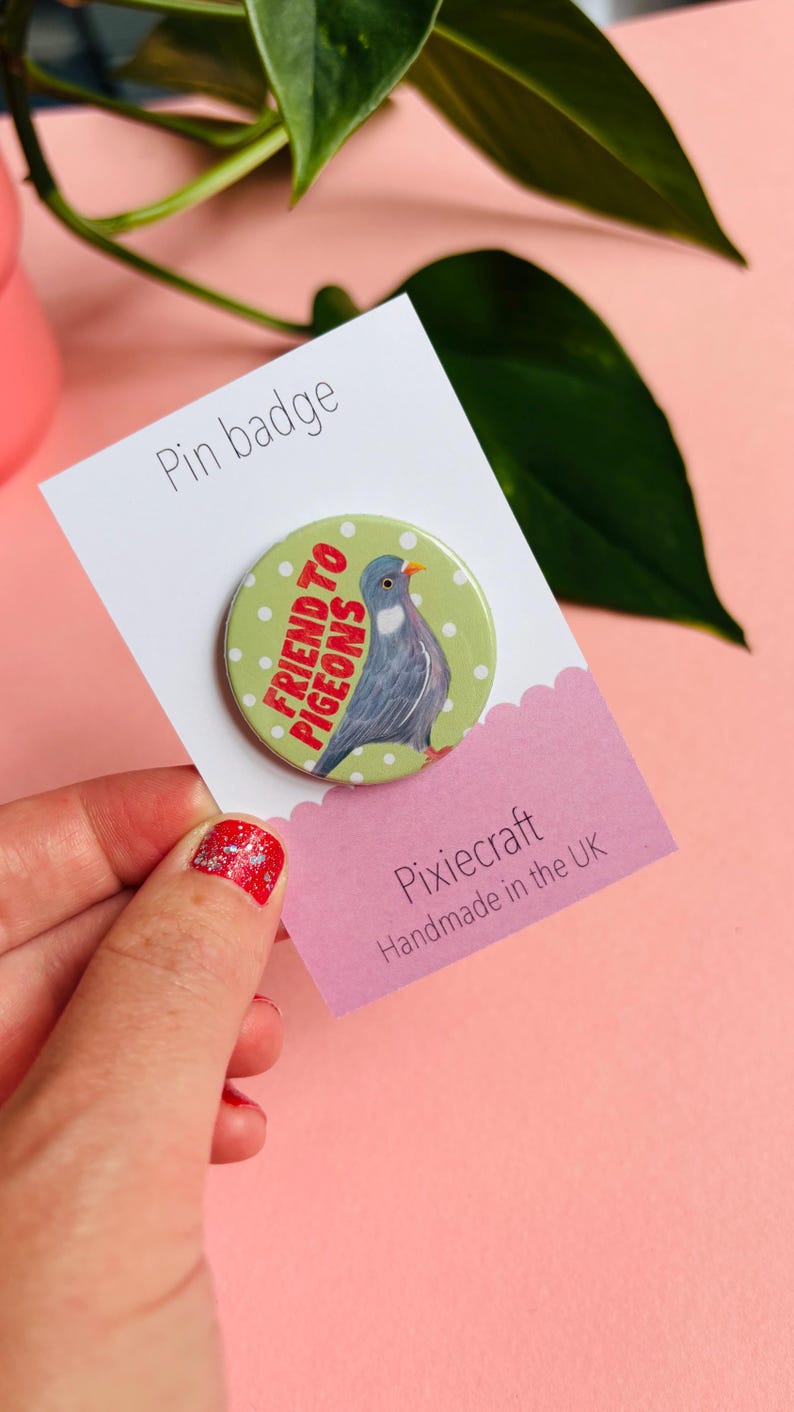cute pigeon hand drawn badge on a green and white polka dot background that reads friend to pigeons