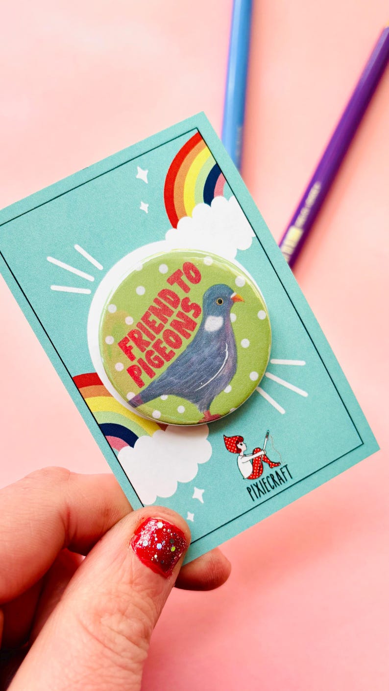 cute pigeon hand drawn badge on a green and white polka dot background that reads friend to pigeons