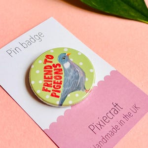 cute pigeon hand drawn badge on a green and white polka dot background that reads friend to pigeons