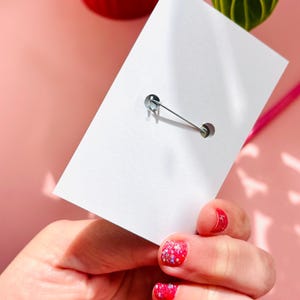 reverse of pin badge on backing card