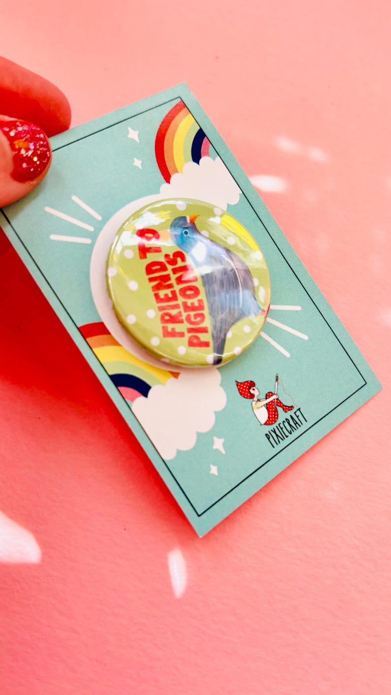 cute pigeon quirky handmade badge m on a green and white polka dot background that reads friend to pigeons. The cute pin is presented on a colourful gift card
